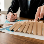 Man points his finger at the wooden blocks