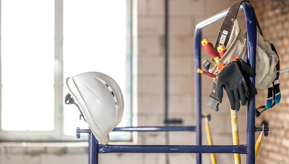 helmet and other builder's accessories in empty room